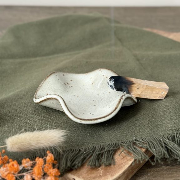Coupelle Léa en céramique artisanale posée sur une table. Un palo santo posé sur la coupelle.