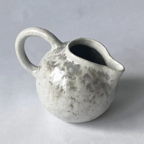 Saucière Cosmos en grès artisanal blanc, pièce unique sur fond clair.