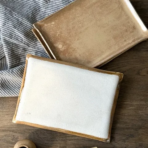 Plat nora en céramique artisanale vu de dessous avec la signature lis